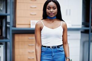 Portrait of a fantastic woman with african american heritage walking in the store. photo