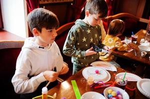 Preparing to Easter concept. Kids making by hands bunny and eggs. photo