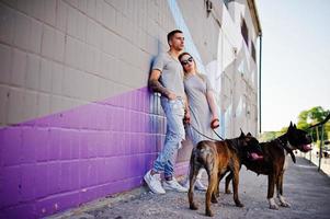 Couple in love with two dogs pit bull terrier on a walk. photo