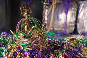 mardi gras crown and beads in green, gold, and purple photo