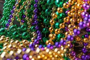 mardi gras beads with bokeh in green, gold, and purple photo