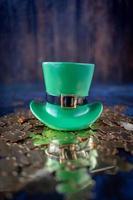 Saint Patricks Day green leprechaun hat on gold shamrocks photo