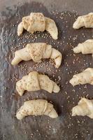 ready to cook crescent rolls with sesame seeds flat lay photo