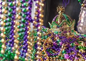 mardi gras crown and beads in green, gold, and purple photo