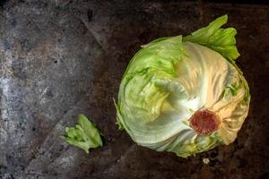 lettuce iceberg head on metal tray flat lay photo