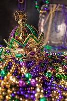 mardi gras crown and beads in green, gold, and purple photo