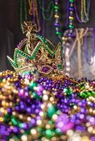 mardi gras crown and beads in green, gold, and purple photo