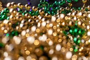 mardi gras beads with bokeh in green, gold, and purple photo