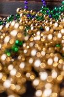 mardi gras beads with bokeh in green, gold, and purple photo