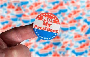 Campaign sticker on finger saying Not my President in dispute over the legal ballot voting photo
