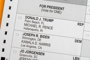 Close up macro of mail-in paper ballot for 2020 presidential election with focus on candidates photo