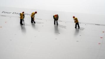 Calendar illustrating a four day working week with small construction workers photo