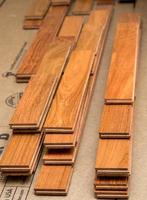 Stack of planks of brazilian Cherry hardwood flooring pieces ready for installation photo