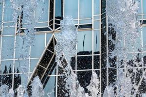 Frozen water of fountain by modern futuristic architecture in downtown Pittsburgh photo