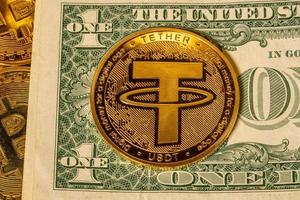 Tether coin concept used as a way of trading in Bitcoin and other alt coins with one dollar bill photo