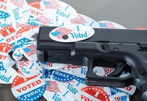 I voted today campaign button with hole on handgun for voter suppression photo