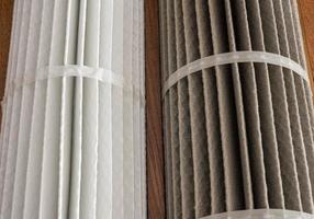 Clean and dirty HVAC filters side by side to illustrate the dfifference photo