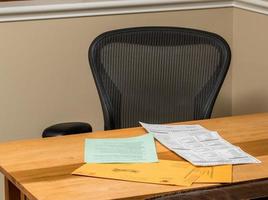 Empty desk at home with the paperwork for completing absentee voting ballot in Presidential election photo