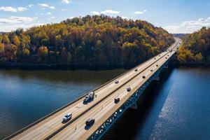 Traffic on the interstate through fall colors on Cheat Lake Morgantown, WV with I68 bridge photo