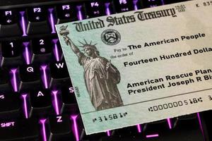 Illustration of the federal stimulus payment check from the IRS on keyboard photo