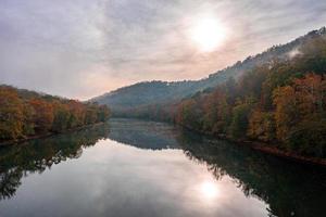 Calm Tygart River by Valley Falls on a misty autumn day photo