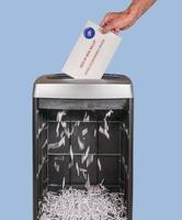 Absentee ballot of vote by mail envelope being shredded in an office shredder photo