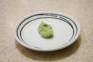 Bowl with Wasabi on table photo