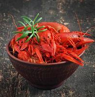 Fresh boiled crawfish on the old wooden background photo