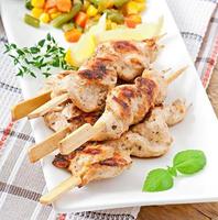 grilled chicken on bamboo skewers photo