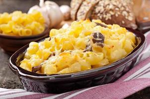 Macaroni with cheese, chicken and mushrooms baked in the oven photo