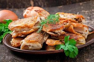 Fish dish - fried fish and herbs photo