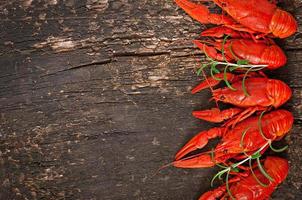 Fresh boiled crawfish on the old wooden background photo