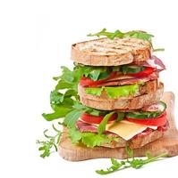 Sandwich with ham, cheese and fresh vegetables photo