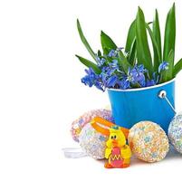 Colorful Easter eggs in a basket on a white background photo