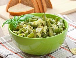 String beans with eggs in bowl. photo