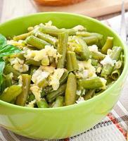 String beans with eggs in bowl. photo