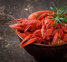 Fresh boiled crawfish on the old wooden background photo