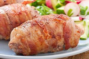 Grilled meat rolls wrapped in strips of bacon photo