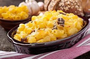 Macaroni with cheese, chicken and mushrooms baked in the oven photo