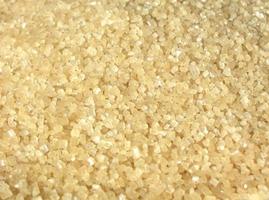 Raw brown sugar from sugar cane photo