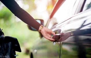 Hand opening the black car door photo