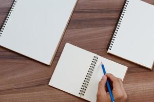 content marketing concept. top view of hand writing on open notebook, mockup for advertise content online. photo