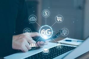 Young man hand holding a phone with a 6G hologram. 6G network wireless systems.The concept of 6G network, high-speed mobile Internet, new generation networks. photo