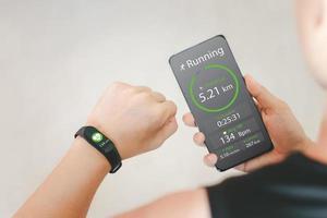 The idea of health care innovation, fitness technology, by wearing a smart watch and smartphone. photo