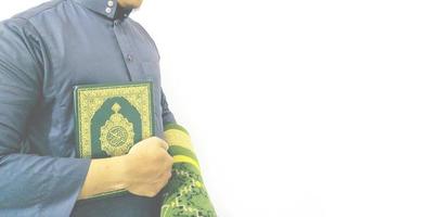 Man Holding and reading quran. Islamic Background photo