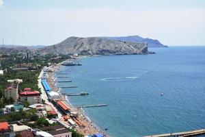 view of the Black Sea and the city of Sudak in Crimea photo