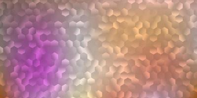 Light pink, yellow vector backdrop with a batch of hexagons.