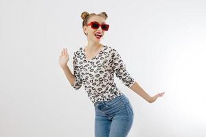 Happy woman isolated on white background. Summer fashion style. Red lipstick and sunglasses. Funny hairstyle and fun summertime. Shopping concept. photo