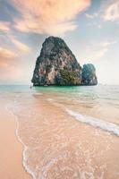 sea, beach and rocky mountains in tropical evening photo