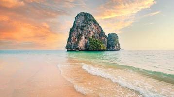 sea, beach and rocky mountains in tropical evening photo